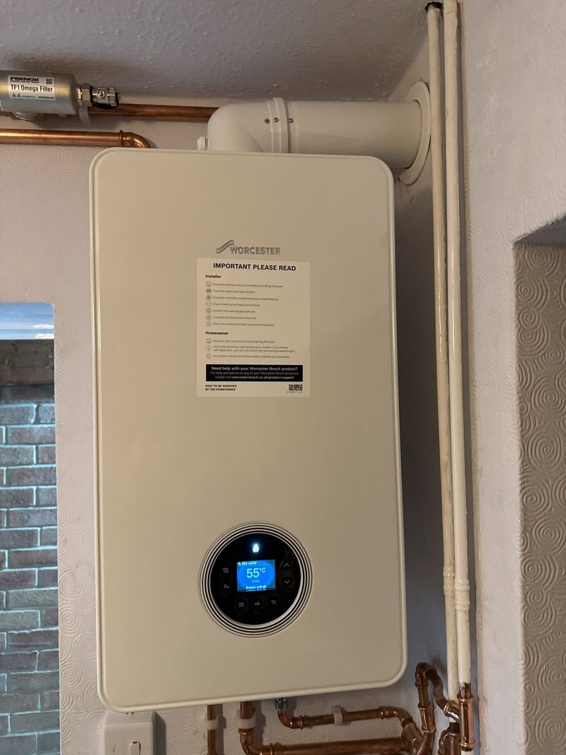 Worcester Bosch boiler with neat copper pipework in a hallway