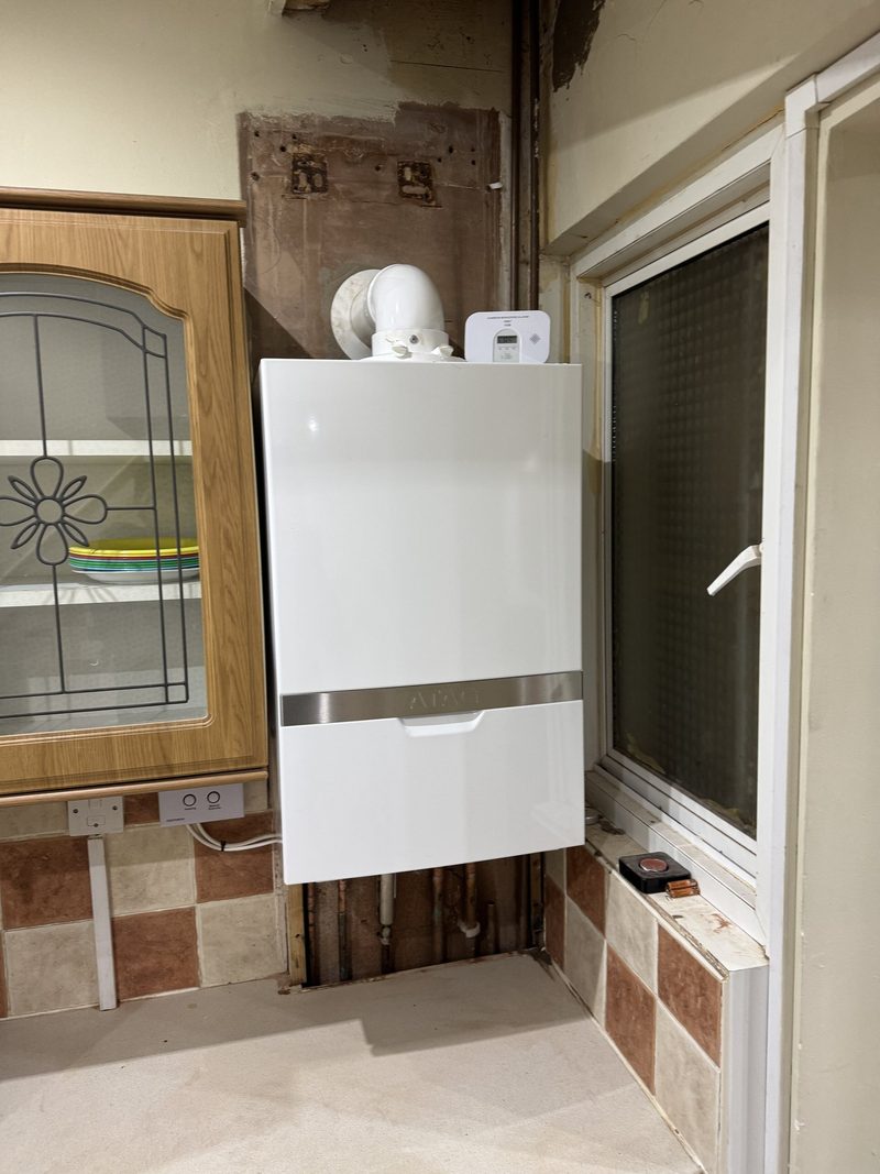 Modern boiler with a neat pipework cover, ready for a system clean